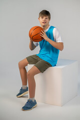 Fototapeta premium A boy in sporstwear with ball in hands