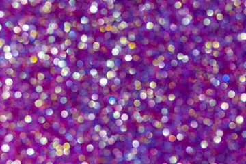 Defocused colorful light bokeh on purple background.