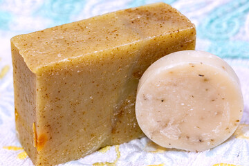 Natural herbal soaps on towel with floral pattern. Handmade natural herbal soaps.