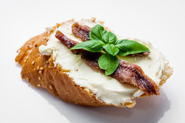 sandwich with anchovy fillets on a serving tray on a white background
