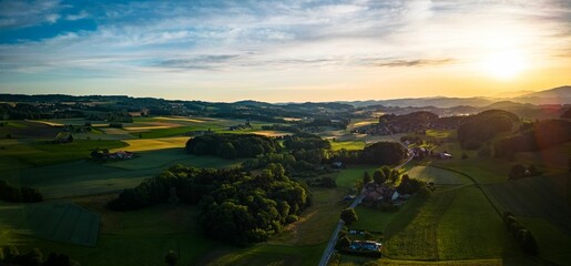 Aerial view of lush green village in Switzerland during sunset