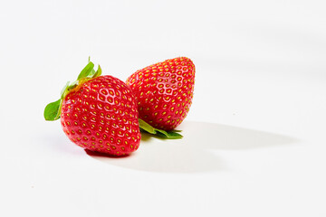 Two strawberries on a white background
