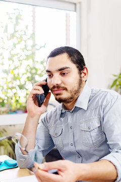 Smiled Adult Man, Having A Conversation With His Superior On The Phone.