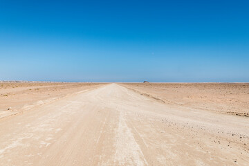 Sandy Track going into the desert with clear blue sky, copy space