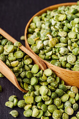 dried green peas on a black stone background