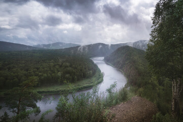 foggy morning in a hilly valley landscape river, atmospheric mood