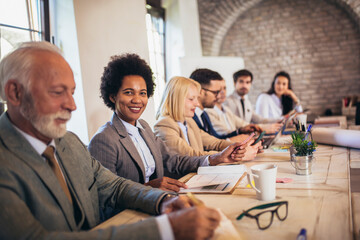Business team taking notes during conference in the office