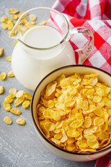 crispy golden cornflakes on a gray concrete background