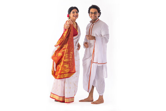 Portrait of Bengali couple looking and pointing at camera
