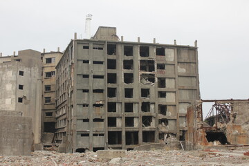 Battleship Island front view of an old broken building. Scary buildings at Hashima Island Japan