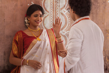 Bengali couple standing at puja pandal on the occasion of Durga Puja