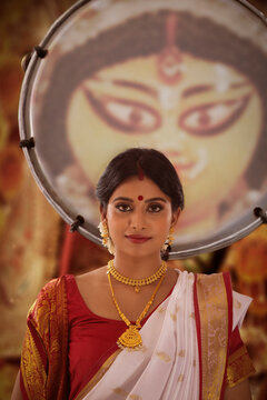 Bengali woman standing front of goddess durga