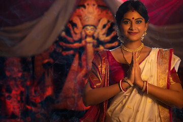 Portrait of young Bengali woman greeting on the occasion of Durga Puja