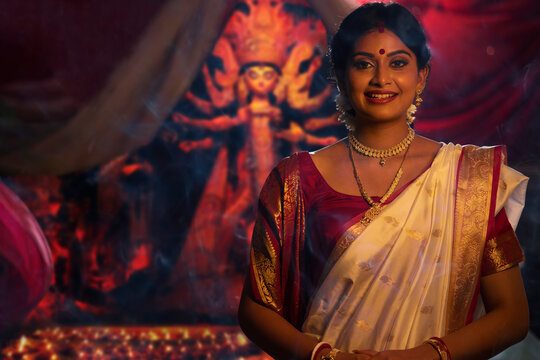 Portrait of young Bengali woman in traditional outfit on the occasion of Durga Puja