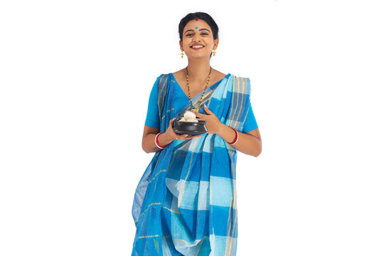 Portrait of Bengali woman standing with a rosogolla handi