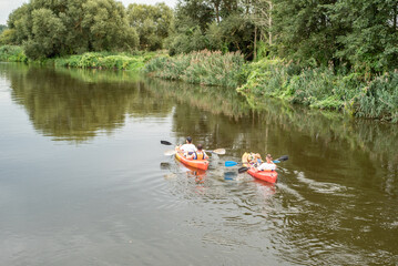Two boats with people on the river, kayaking trip