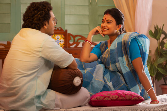 Portrait Of Bengali Couple Talking On Bed