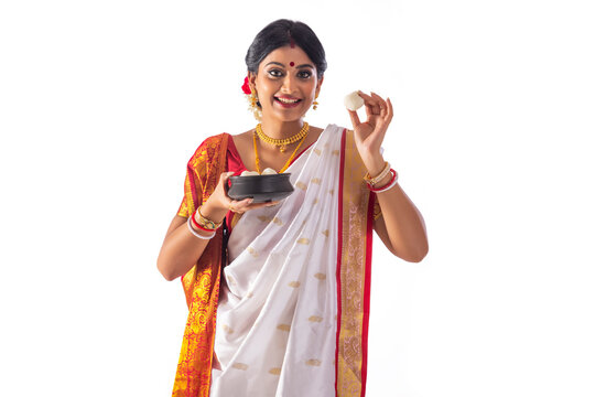 Portrait of Bengali woman standing with a rosogolla handi