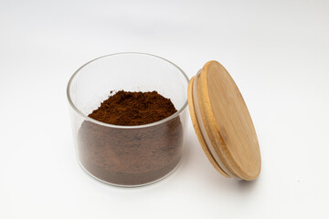 Ground coffee in a jar on a white background