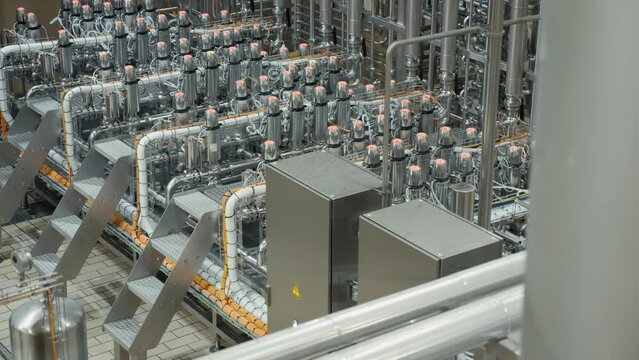 Modern craft brewery with steel pipelines, tanks reservoirs and technique equipment. Craft beer production.