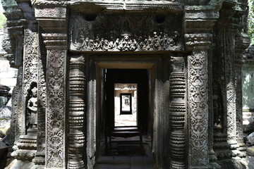 Fototapeta na wymiar Ta Prohm Temple Doorway with Light, Shadows, and Ornate Decor
