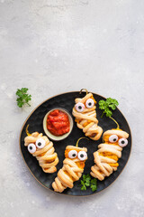 Stuffed jalapeno peppers look like a mummies for Halloween party food