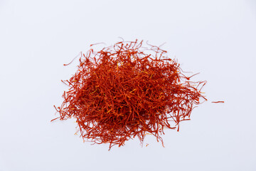 Red stamens of saffron on a white background. Dry spices of saffron threads.