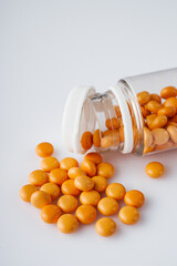 orange valerian pills on a white acrylic background