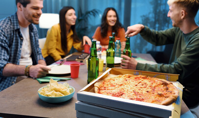 Friends eating pizza together at home