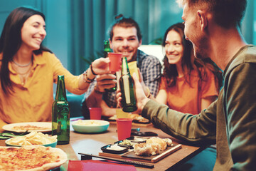 Friends eating and toasting together