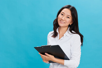 Smiling to you cute Asian businesswoman in classic office dress code holds folder tablet with...