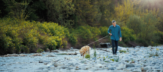 Man and dog walking in nature