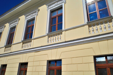 Fragment of the facade of a historic building on a summer day