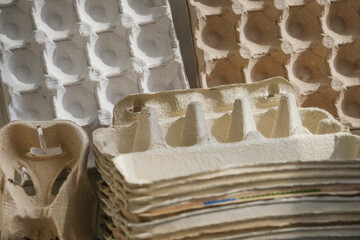 Many cardboard packs and empty egg carton boxes on a grey wall background, reusable packaging and recycling food package