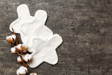 set of colorful bright reusable menstrual pads with cotton flower. zero waste woman periods concept top view with copy space