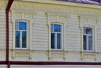 Fragment of the facade of a historic building on a summer day