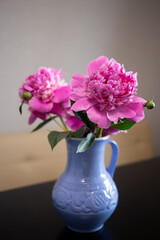 beautiful fresh pink peonies in a crock blue jug