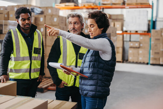 Female warehouse manager discussing with her team during a meeting