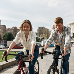 Obraz premium Man and girl resting and riding bicycles in city