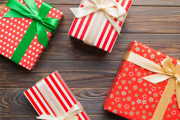 Obraz premium A lot of Christmas gift boxes in colored paper decorated on table, Top view close up. Many present New Year gift