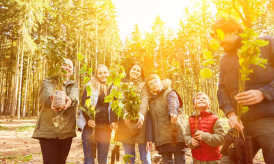 Family planting trees in the forest for environmental protection