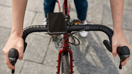 Focus of bicycle with smartphone ride partial girl