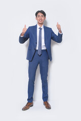Full body young businessman wearing suit, blue shirt with tie with hands, thumbs up  standing in studio