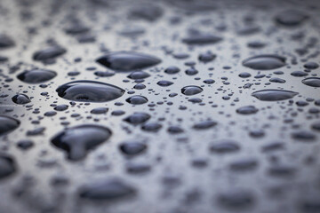 Close up on a raindrops on a car body surface