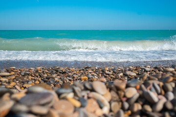 Fototapeta na wymiar Mediterranean sea with waves with stony beach. High quality photo. 