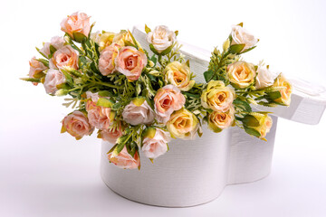 Wedding card, floral still life: in a white box in the shape of a heart are roses close-up