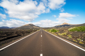 straight road among vineyards and volcanoes in Lanzarote, Canaray Islands, Spain