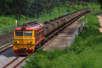 Naklejka premium Tanker-freight train by diesel locomotive on the railway.