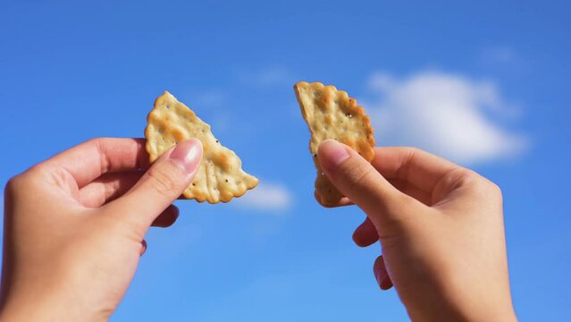 Splitting up cracker under blue sky