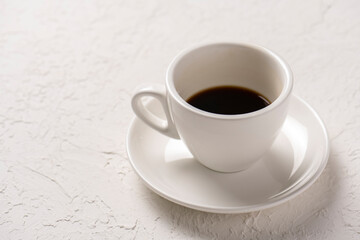 close-up shot of cup of coffee on white tabletop